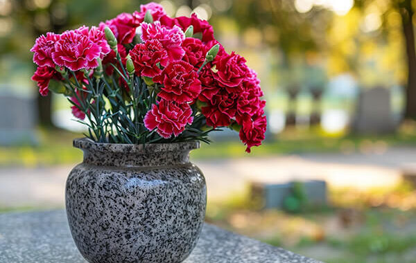 a_bouquet_of_carnations_placed_in_a_gravestone