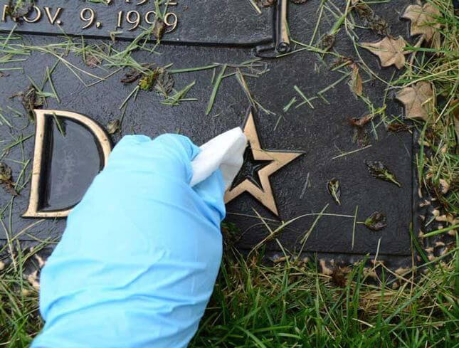Cleaning memorial plaque